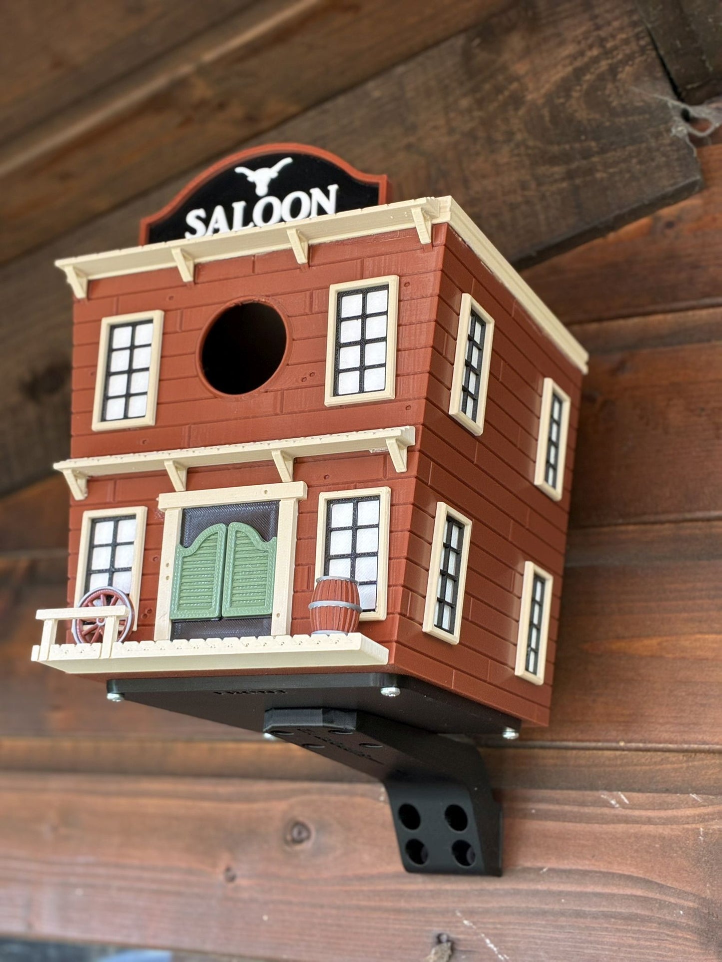 Western Saloon themed 3D printed birdhouse mounted outdoors on garden shed