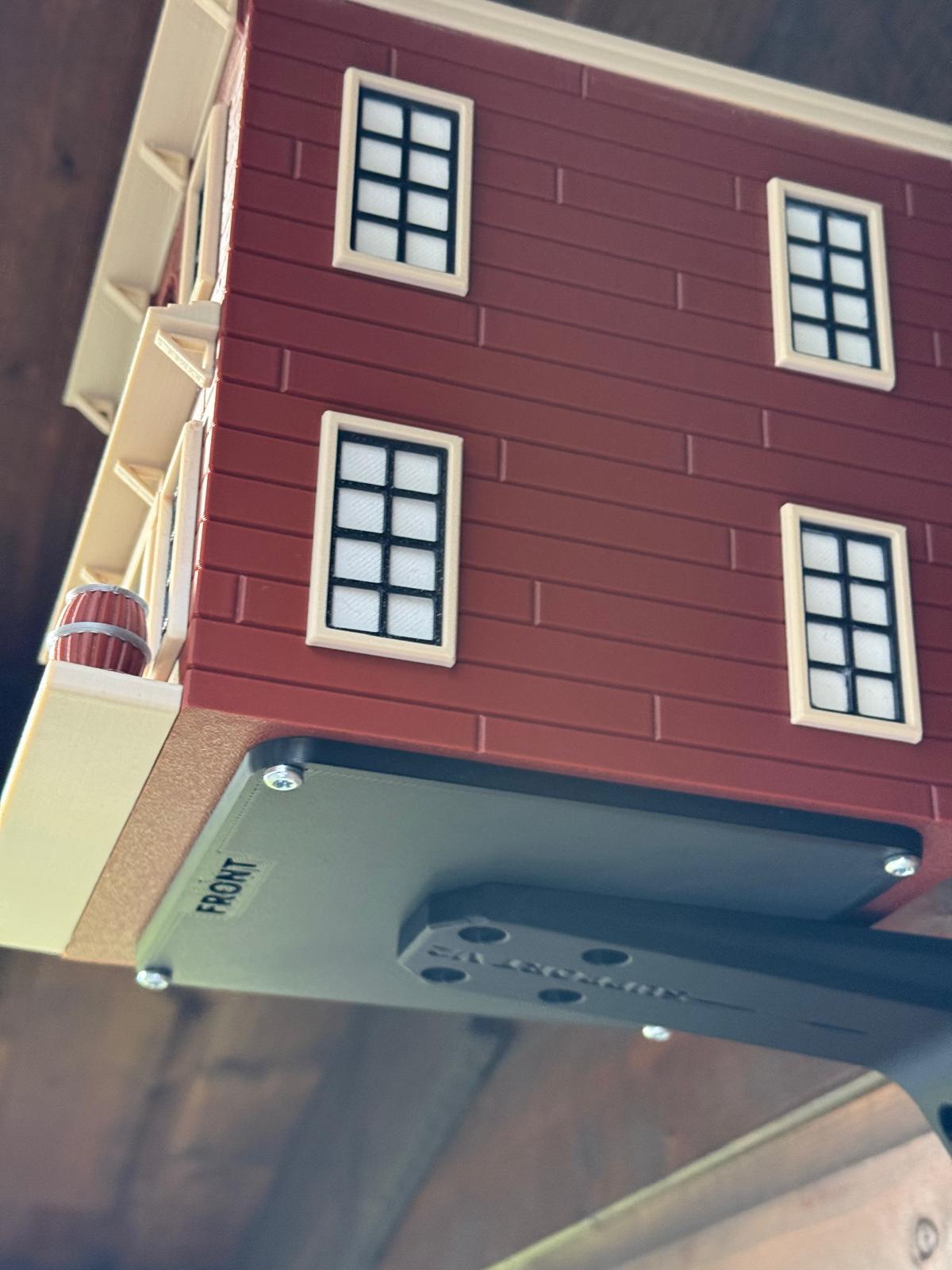 Western Saloon themed 3D printed birdhouse mounted outdoors on garden shed