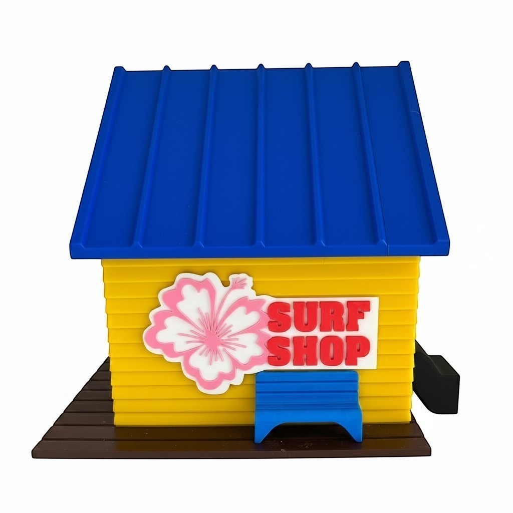 TL3D Prints yellow 3D printed surf shop birdhouse with blue roof, hibiscus flower, and "SURF SHOP" sign.