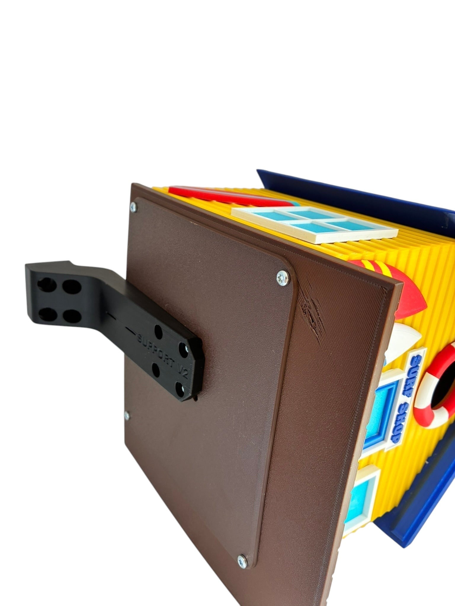 TL3D Prints Surf Shop birdhouse, yellow with blue windows, red surfboard, and lifebuoy detail. 3D printed PETG.